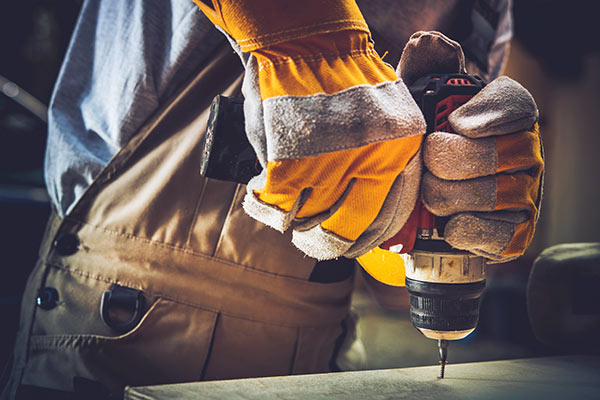 Worker Using Drill