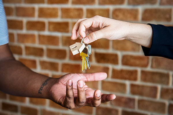 Real Estate Agent Handing Over House Keys